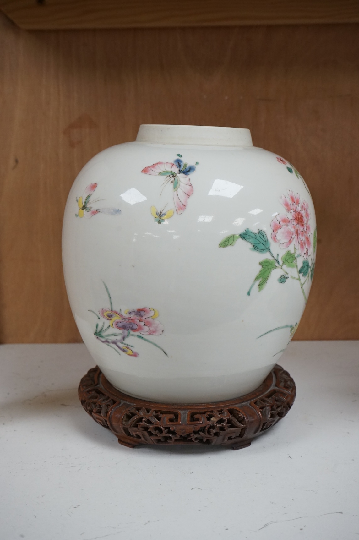 A late 19th century Chinese famille rose 'pheasant' jar lacking cover, with finely carved wooden stand, 21.5cm high including stand.